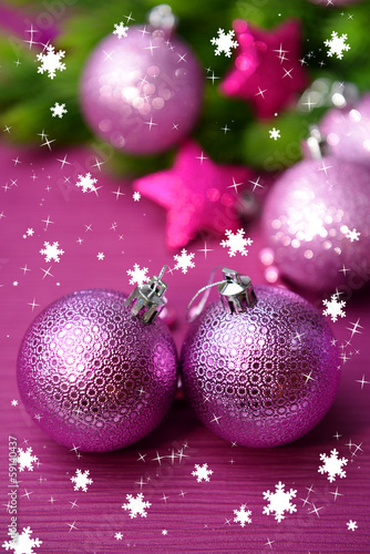 Photo: Christmas balls on fir tree, on color background Christmas balls on fir tree, on color background