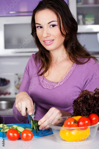 Photo: Pretty woman cooking food in the kitchen Pretty woman cooking food in the kitchen