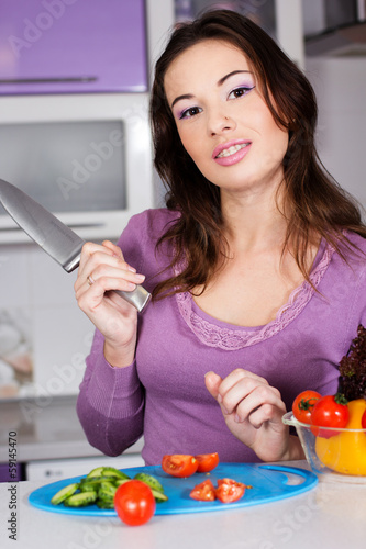 Photo: Pretty woman cooking food in the kitchen Pretty woman cooking food in the kitchen