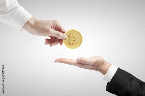 Photo: hand giving bitcoin hand giving bitcoin