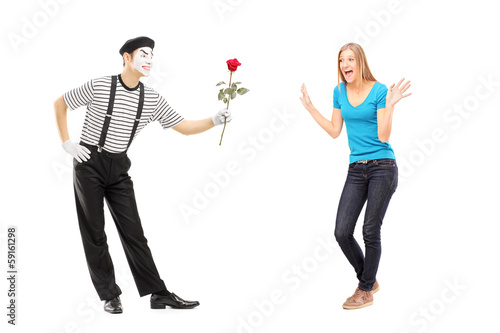 Photo: Mime artist giving a rose flower to an excited woman Mime artist giving a rose flower to an excited woman