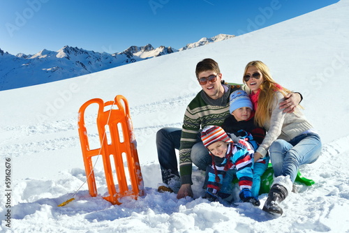 Photo: family having fun on fresh snow at winter vacation family having fun on fresh snow at winter vacation
