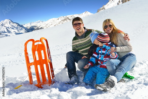 Photo: family having fun on fresh snow at winter vacation family having fun on fresh snow at winter vacation