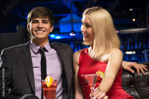 Photo: Young couple talking in a nightclub Young couple talking in a nightclub