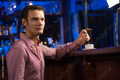 Photo: man with a cup of coffee man with a cup of coffee