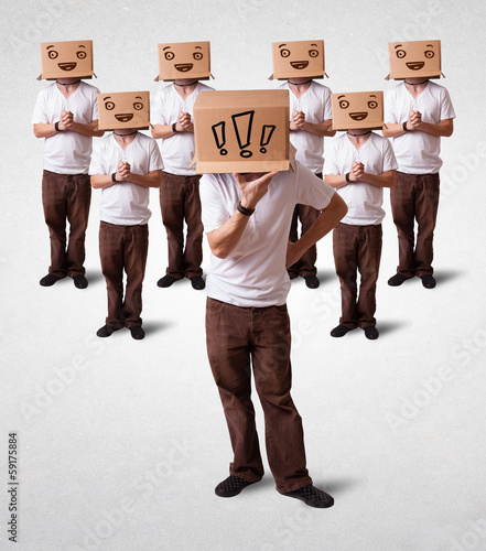 Photo: Men gesturing with exclamation marks on box on their head Men gesturing with exclamation marks on box on their head