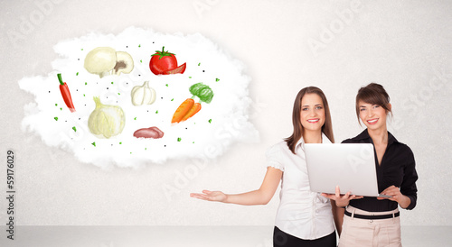 Photo: Young girl presenting nutritional cloud with vegetables Young girl presenting nutritional cloud with vegetables