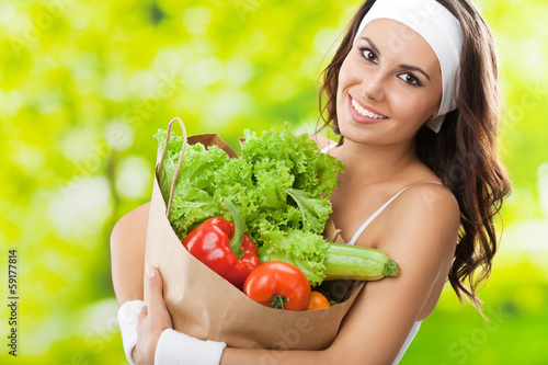 Photo: Woman in fitness wear with vegetarian food Woman in fitness wear with vegetarian food
