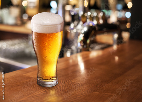 Photo: Beer glass on a bar. Beer glass on a bar.