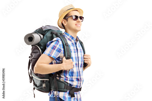 Photo: Male tourist with backpack walking Male tourist with backpack walking