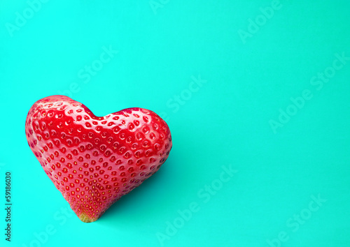 Photo: One rich strawberry fruit in form of heart. One rich strawberry fruit in form of heart.
