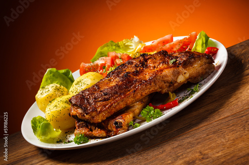 Photo: Tasty grilled ribs with vegetables Tasty grilled ribs with vegetables