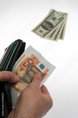 Photo: Banconote estratte dal portafogli. Cambio euro dollaro Banconote estratte dal portafogli. Cambio euro dollaro