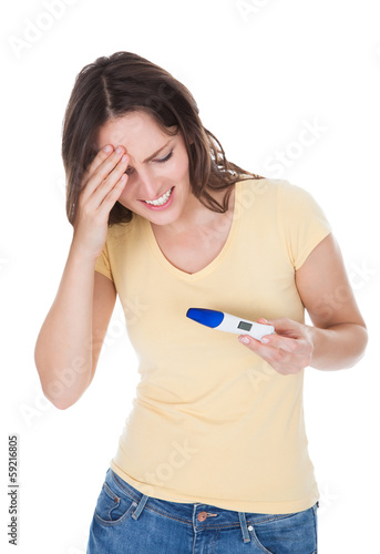Photo: Worried Woman Looking At Pregnancy Result Worried Woman Looking At Pregnancy Result