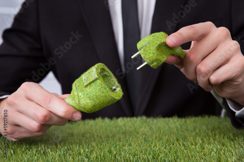 Photo: Man Holding Grass Covered Cable Man Holding Grass Covered Cable