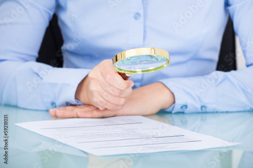 Photo: Businesswoman Holding Magnifying Glass Businesswoman Holding Magnifying Glass