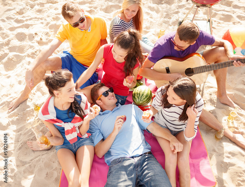 Photo: group of friends having fun on the beach group of friends having fun on the beach