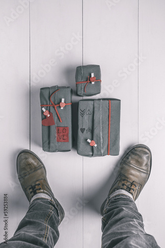 Photo: Man boots with valentines gifts box. Hipster ornaments. Man boots with valentines gifts box. Hipster ornaments.