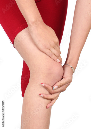 Photo: Girl massaging pain knee Girl massaging pain knee