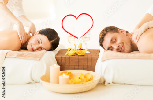 Photo: couple getting massage in spa salon couple getting massage in spa salon