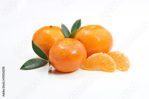 Photo: three tangerines and a peeled chunks three tangerines and a peeled chunks