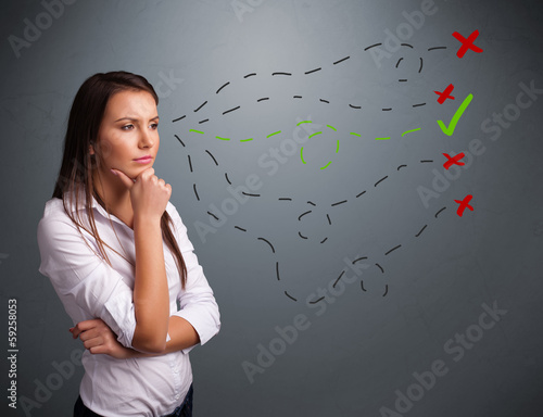 Photo: Young woman choosing between right and wrong signs Young woman choosing between right and wrong signs