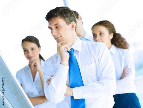 Photo: businessmen are meeting near the flipchart businessmen are meeting near the flipchart