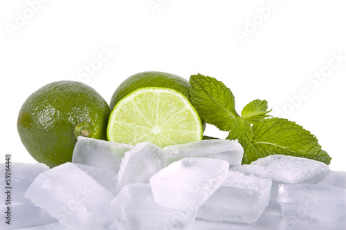 Photo: limes with mint leaves on white background limes with mint leaves on white background