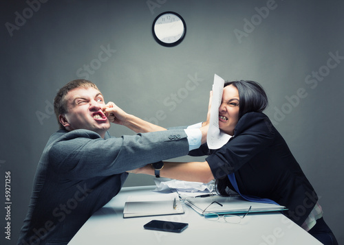 Photo: Two young caucasian office worker starting to fight Two young caucasian office worker starting to fight