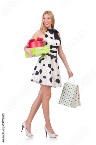 Photo: Young woman with christmas shopping on white Young woman with christmas shopping on white