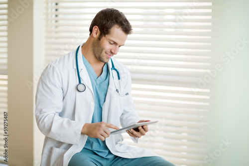 Photo: Cancer Specialist Using Digital Tablet At Clinic Cancer Specialist Using Digital Tablet At Clinic