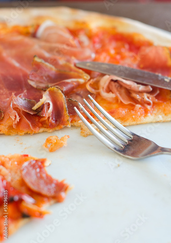 Photo: Closeup view of half pizza on a plate Closeup view of half pizza on a plate