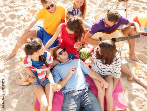 Photo: group of friends having fun on the beach group of friends having fun on the beach