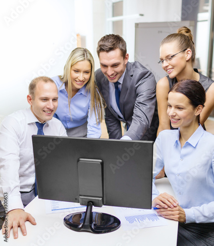 Photo: business team with monitor having discussion business team with monitor having discussion