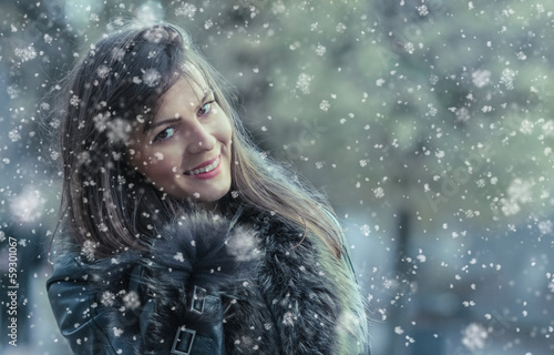 Photo: Portrait of a smile young woman in a winter snow Portrait of a smile young woman in a winter snow