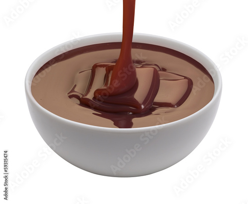 Photo: melted chocolate being poured in a white cup melted chocolate being poured in a white cup