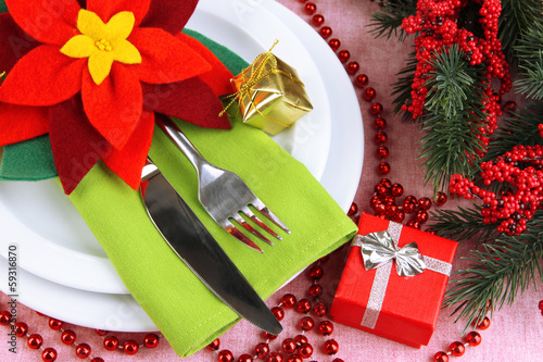 Photo: Christmas table setting with festive decorations close up Christmas table setting with festive decorations close up