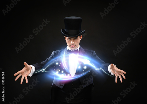 Photo: magician in top hat showing trick magician in top hat showing trick
