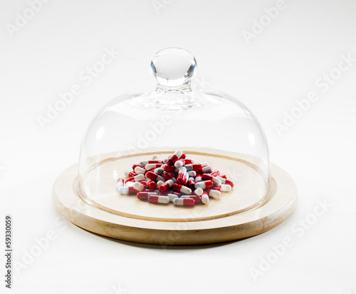 Photo: piles of red and white pills under cover piles of red and white pills under cover