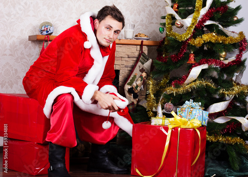 Photo: Young man wearing like Santa clause. Christmas Young man wearing like Santa clause. Christmas