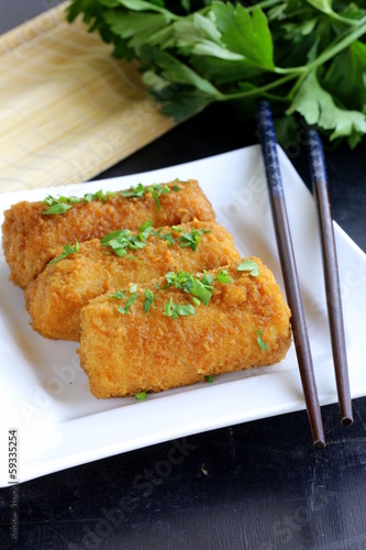 Photo: fried spring rolls with herbs and sauce on a plate fried spring rolls with herbs and sauce on a plate
