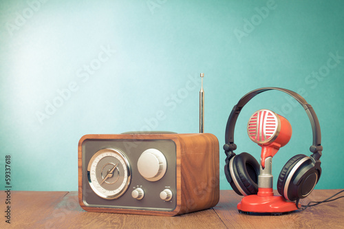 Photo: Retro radio, red microphone, headphones on table old style photo Retro radio, red microphone, headphones on table old style photo