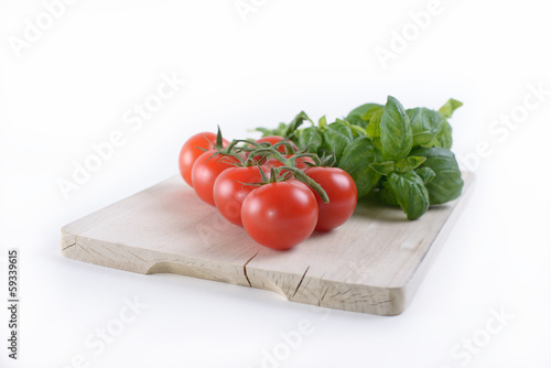 Photo: A board with tomato and basil A board with tomato and basil