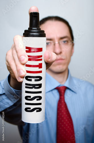Photo: Businessman with anticrisis spray. Businessman with anticrisis spray.