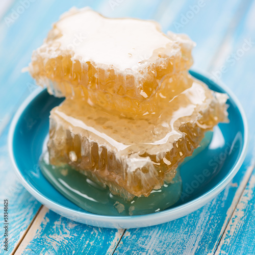 Photo: Honeycomb pieces in a saucer, close-up Honeycomb pieces in a saucer, close-up