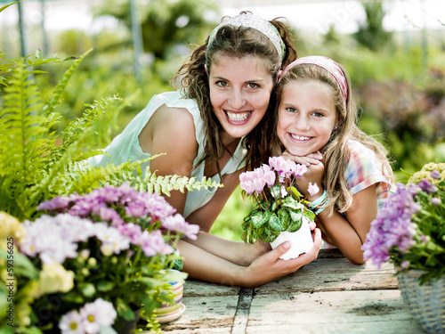 Photo: Mom and daughter have fun in the work of gardening Mom and daughter have fun in the work of gardening