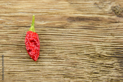 Photo: chili pepper on wood background chili pepper on wood background