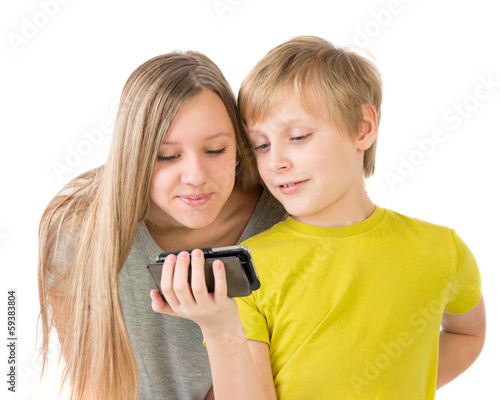 Photo: Boy and girl looking at phone Boy and girl looking at phone