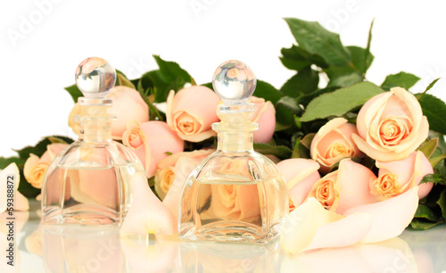 Photo: Beautiful bouquet of roses and perfume, isolated on white Beautiful bouquet of roses and perfume, isolated on white