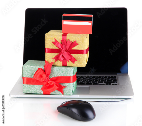 Photo: Laptop, gifts and computer mouse isolated on white Laptop, gifts and computer mouse isolated on white